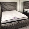 Alt Text: "Luxury tufted bed with a Due Ortho Memory Dual Season Mattress, featuring a plush upholstered headboard and footboard in a gray, button-tufted fabric